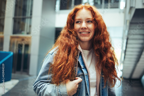 Smiling female student in college campus