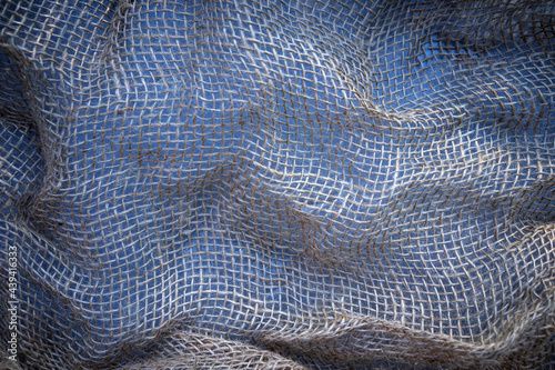 Photo of the texture of a brown woven bag in a small square mesh