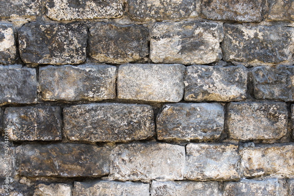 Old wall made of rough stone blocks as a background Old wall made of rough stone blocks as a background