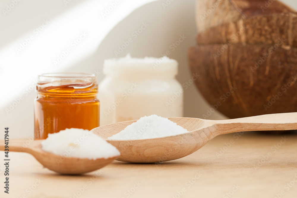 Coconut oil in jar and wooden spoon. Nature body, face, hair care concept. Coconut oil in jar and wooden spoon. Nature body, face, hair care concept.