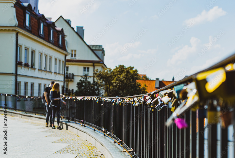 couple at the railing with many padlocks attached