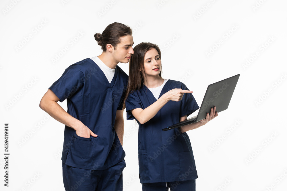 Fototapeta premium Two doctor and nurse research and hold laptop computer in hands finger pointing digital screen isolated on a white background