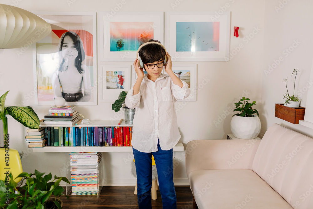 Teen Boy dancing and singing in colorful room with books and photo wall gallery Teen Boy dancing and singing in colorful room with books and photo wall gallery