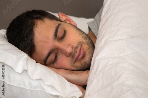 portrait young man sleeping in bed