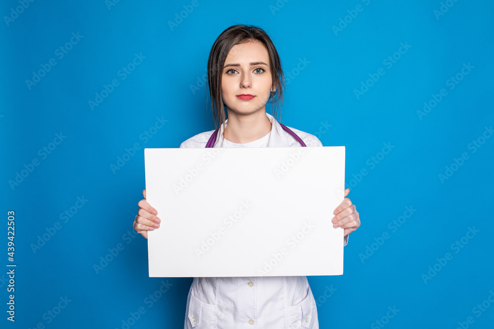 medical doctor woman smile hold blank card board on blue background medical doctor woman smile hold blank card board on blue background