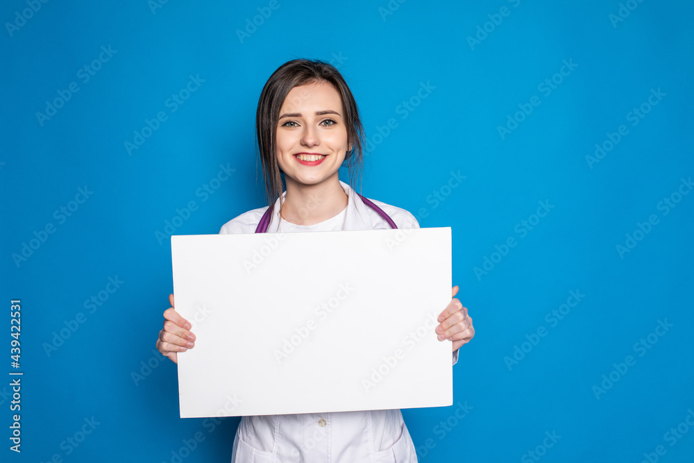 medical doctor woman smile hold blank card board on blue background medical doctor woman smile hold blank card board on blue background
