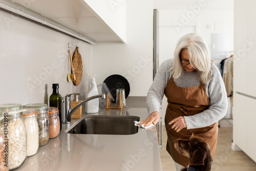 mature woman cleaning the kitchen