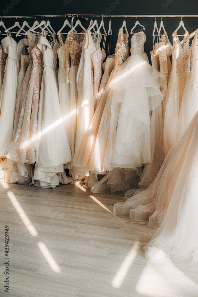 Wedding dresses on a clothes rail in a bridal shop Wedding dresses on a clothes rail in a bridal shop