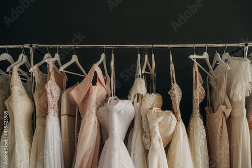 Wedding dresses on a clothes rail in a bridal shop photo