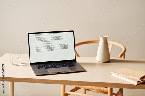Laptop on table in minimalist style workplace photo