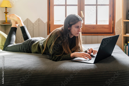 Woman In Bed With Laptop