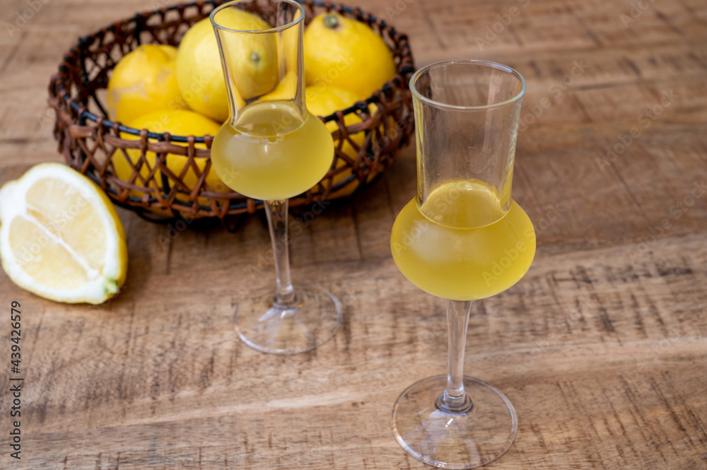 Fototapeta premium Glasses of cold sweet italian strong alcoholic liquor limoncello made from fresh lemons.