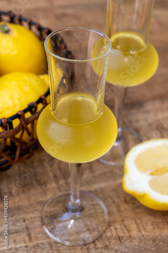 Glasses of cold sweet italian strong alcoholic liquor limoncello made from fresh lemons.