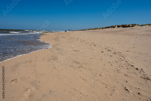 Yellow sandy beach in small Belgian town De Haan or Le Coq sur mer  luxury vacation destination  summer holidays