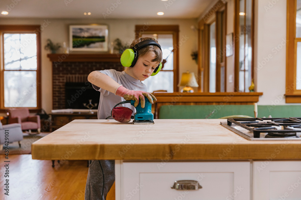 Young Woodworker using hand Sander Young Woodworker using hand Sander