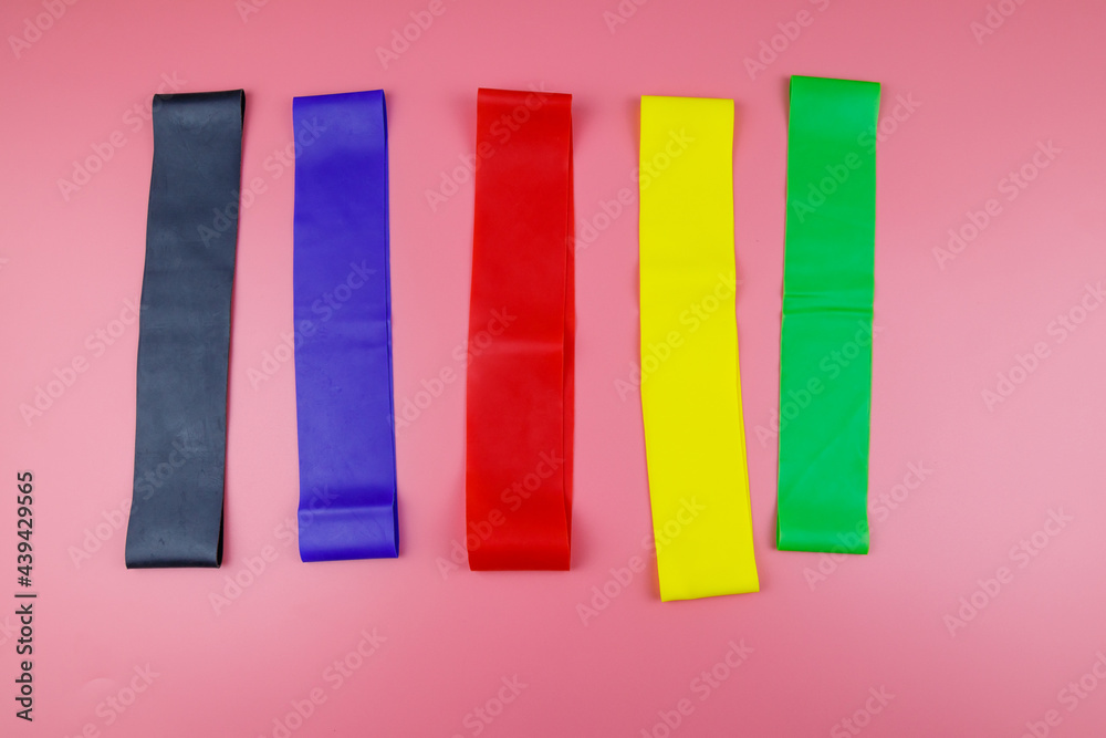 Set of elastic rubber bands for fitness on a pink background. Top view Set of elastic rubber bands for fitness on a pink background. Top view