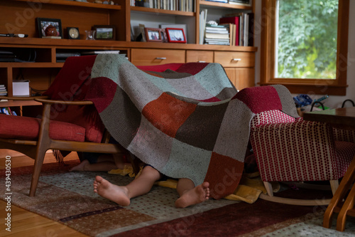 Child Watching Ipad Tablet inside Homemade Tent Fort at Home 