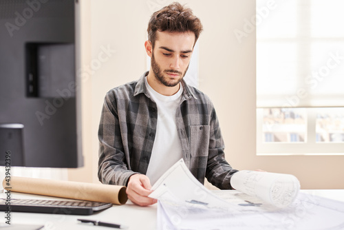 Serious architect with paper drafts photo