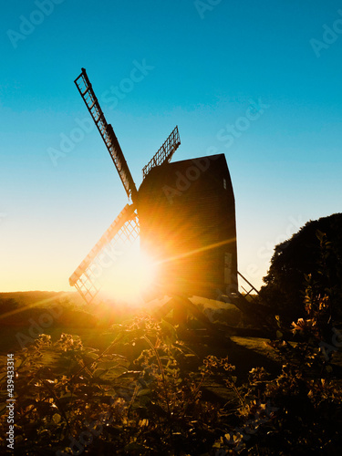 Old traditional windmill silhouette at sunset