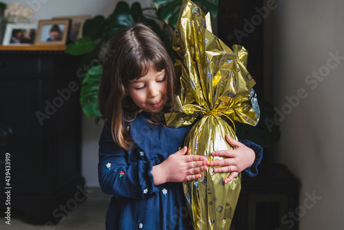 Little Girl Holding a Chocolate Easter Egg photo