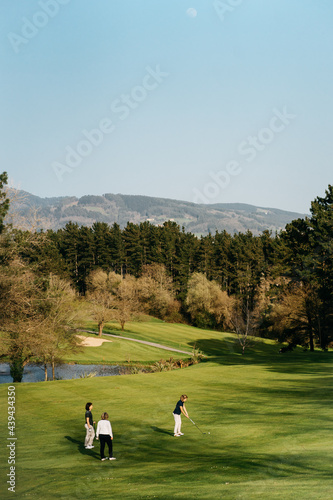 Women playing golf in park photo