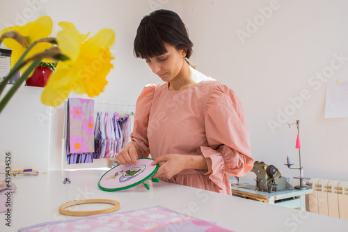 Young woman in her embroidery studio photo