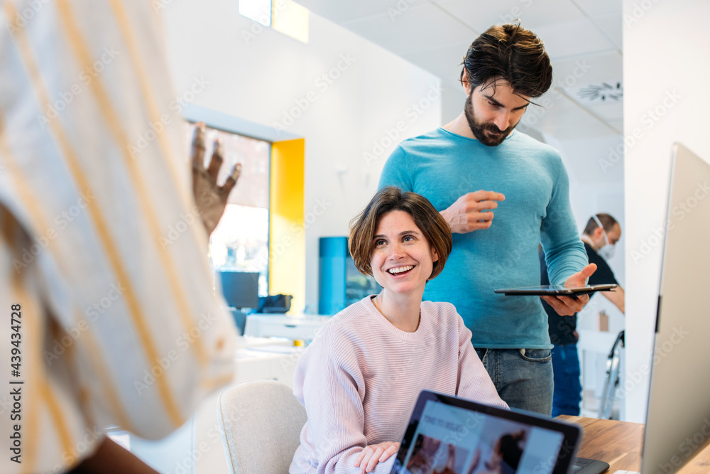 Multiracial coworkers working with gadgets in office Multiracial coworkers working with gadgets in office