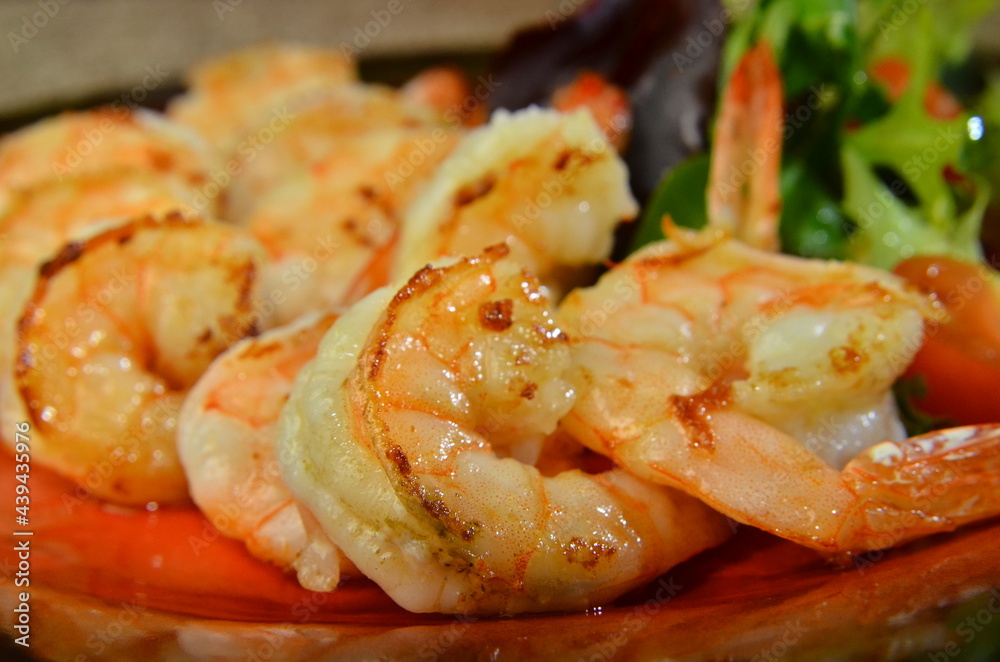 fried roasted shrimps in plate with wegetables fried roasted shrimps in plate with wegetables