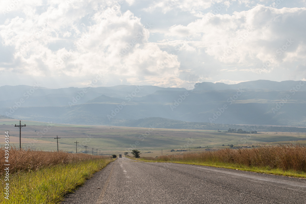 Scenic rural road with Drakensberg mountain range