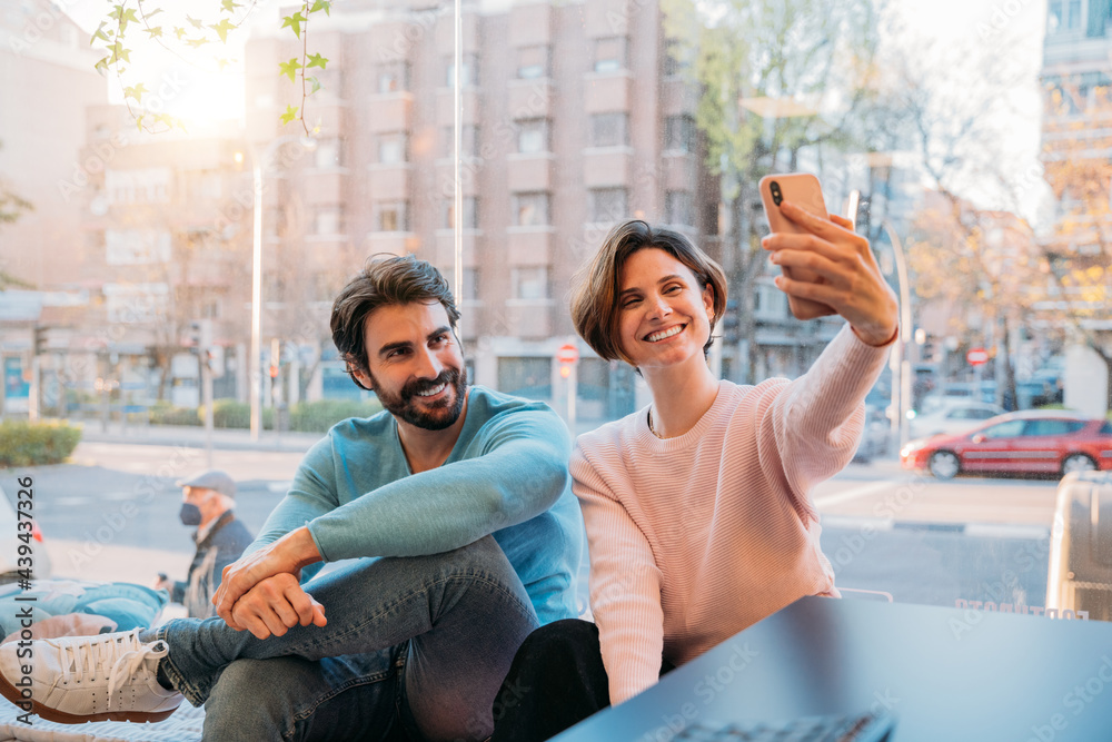 Two coworkers taking a selfie in the office Two coworkers taking a selfie in the office