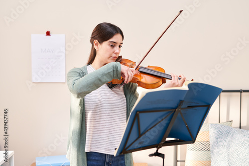 Woman practicing violin. photo