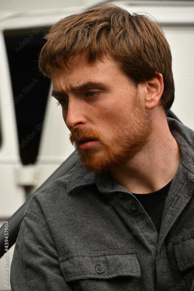 Sexy red haired male musician playing the bass