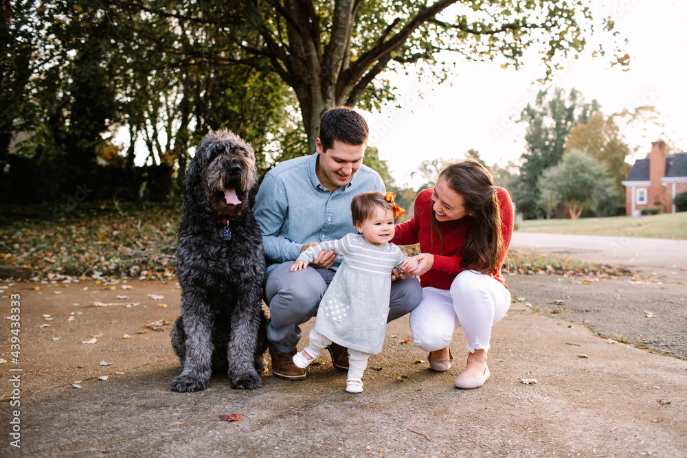 Attractive Young Mom and Dad in Driveway with Toddler and Dog