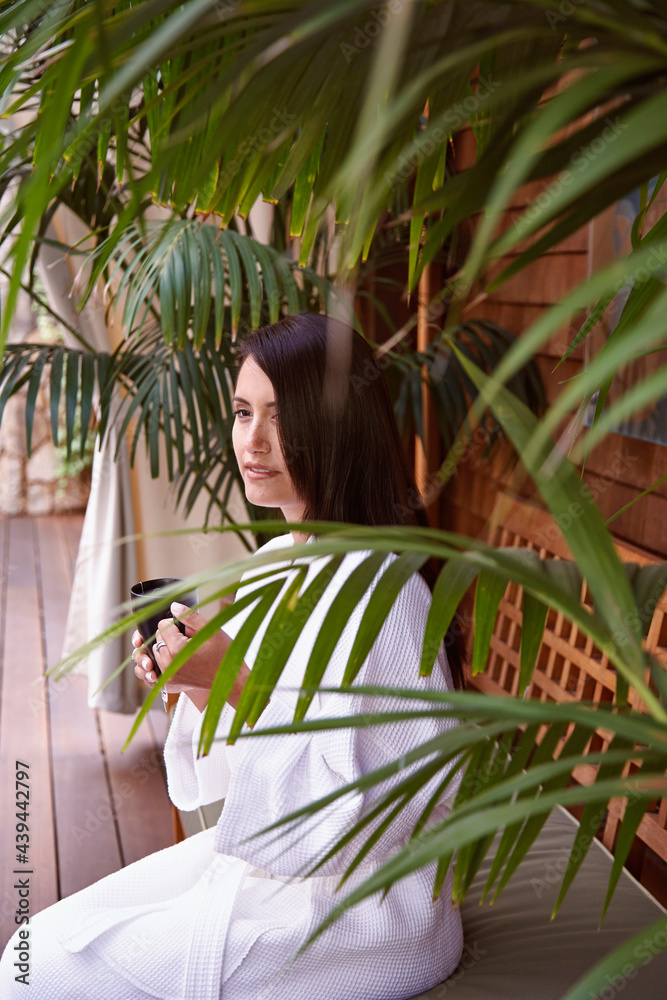 Woman drinking tea in bathrobe at spa Woman drinking tea in bathrobe at spa
