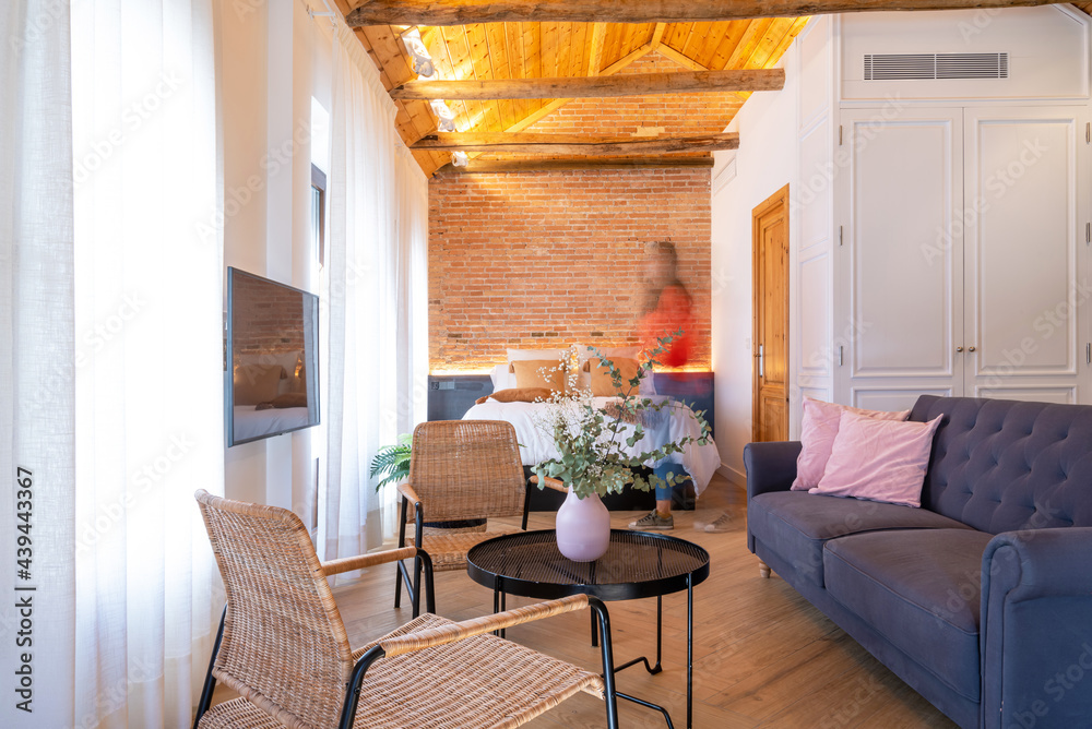 © Bisual Studio/Stocksy - Woman walking through room in hurry