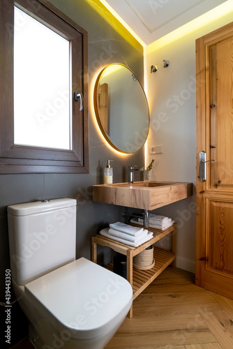 Shelves with toiletries near toilet and mirror