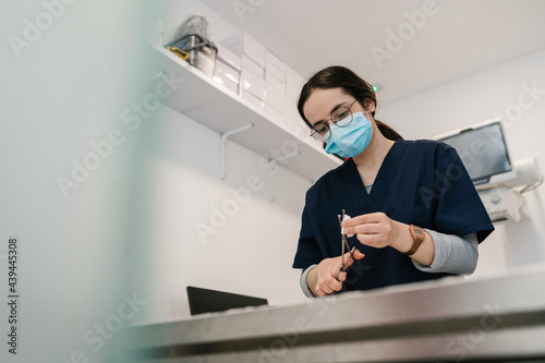 Vet doctor preparing instruments for operation