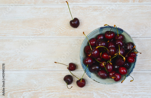 fresh and ripe cherry in a ceramic bowl, sweet summer berry