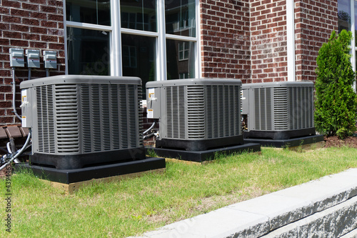 AC units attached to apartment building photo