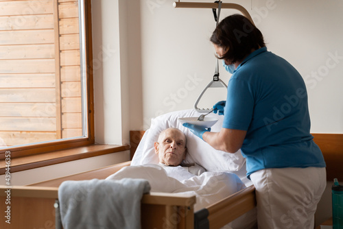 Nurse Providing Food To Patient In The Bed