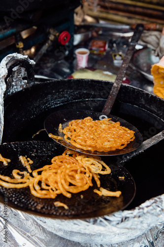 Fried Indian sweets like doughnuts in honey