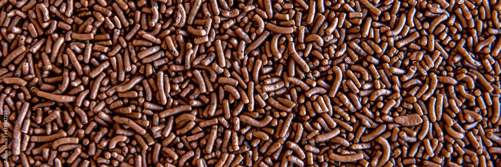 Chocolate sprinkles texture background. Outdoor format. Chocolate sprinkles texture background. Outdoor format.