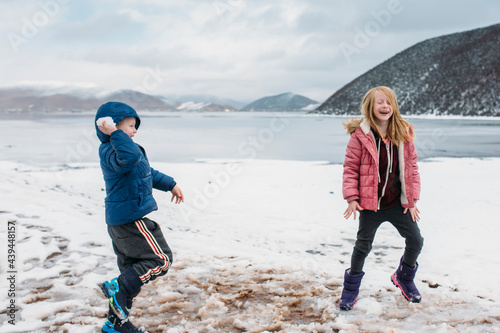 Two kids play in the snow on a high plateau  photo