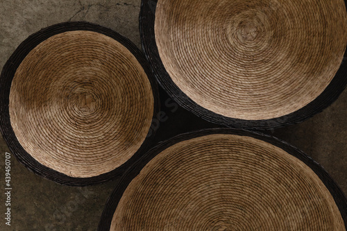 Black and tan woven baskets on a concrete surface photo