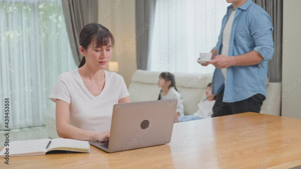 Asian loving husband serve coffee, take care wife while work from home Asian loving husband serve coffee, take care wife while work from home