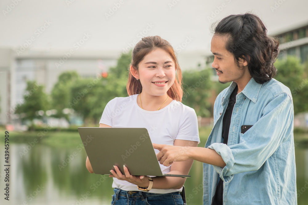 Man and woman using computer business technology outdoor Man and woman using computer business technology outdoor