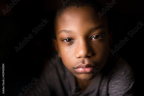 High contrast portrait of a serious young boy