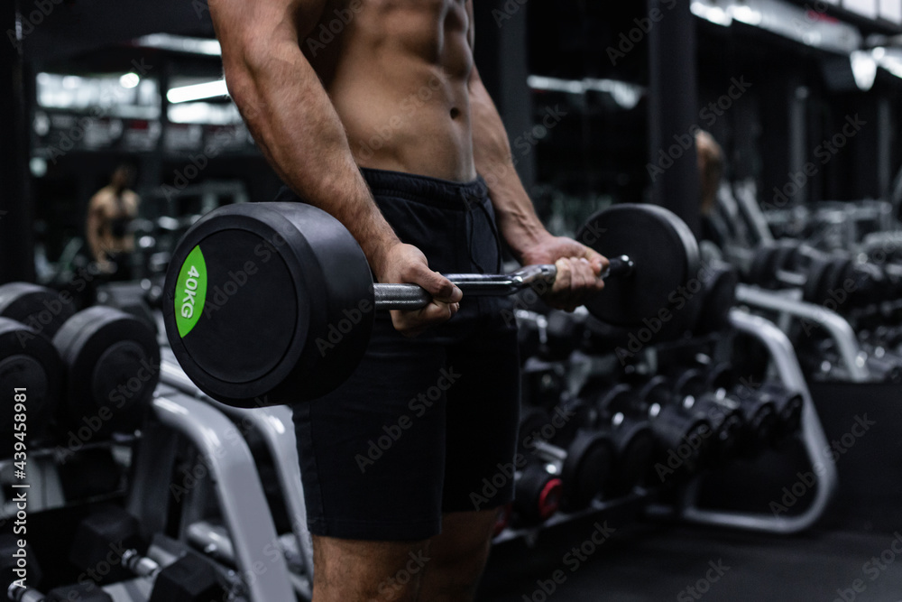 Man Lifts Weights In A Gym