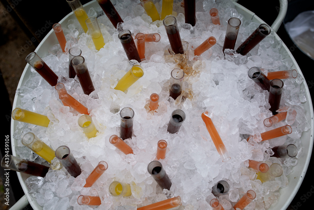 A lot funny tubes for beverage with crushed ice in a bucket A lot funny tubes for beverage with crushed ice in a bucket