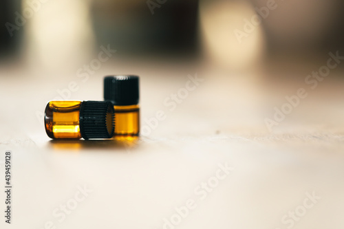 Close up image of 1ml amber essential oil vial. Health and wellness sample with copy space. photo